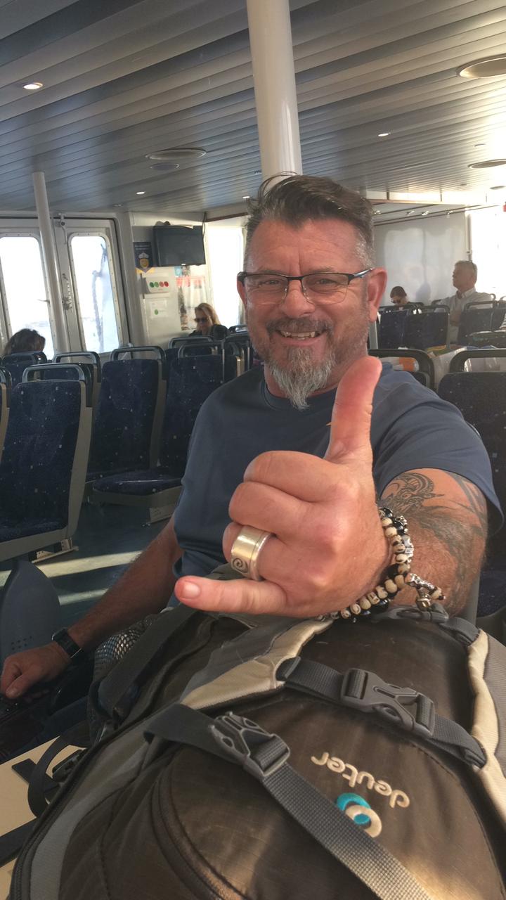 Harrison Caine smiling while travelling